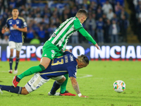 Leonardo Castro of Millonarios and Felipe Aguirre of Atletico Nacional fight for the ball during the match on the third date of the semifina...