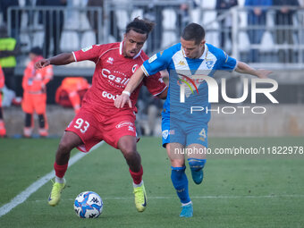 Mehdi Dorval of SSC Bari contrasts with Fabrizio Paghera of Brescia Calcio FC during the Italian Serie B soccer championship match between B...