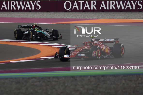 Carlos Sainz of Ferrari and Lewis Hamilton of Mercedes during Sprint ahead of the Formula 1 Grand Prix of Qatar at Lusail International Circ...