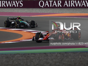 Carlos Sainz of Ferrari and Lewis Hamilton of Mercedes during Sprint ahead of the Formula 1 Grand Prix of Qatar at Lusail International Circ...