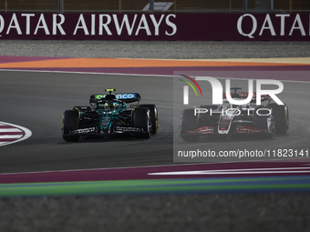 Kevin Magnussen of Haas and Fernando Alonso of Aston Martin Aramco during Sprint ahead of the Formula 1 Grand Prix of Qatar at Lusail Intern...