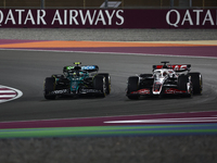 Kevin Magnussen of Haas and Fernando Alonso of Aston Martin Aramco during Sprint ahead of the Formula 1 Grand Prix of Qatar at Lusail Intern...