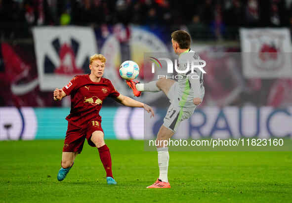 Joakim Maehle of VfL Wolfsburg and Nicolas Seiwald of RB Leipzig battle for the ball during the Bundesliga match between RB Leipzig and VfL...