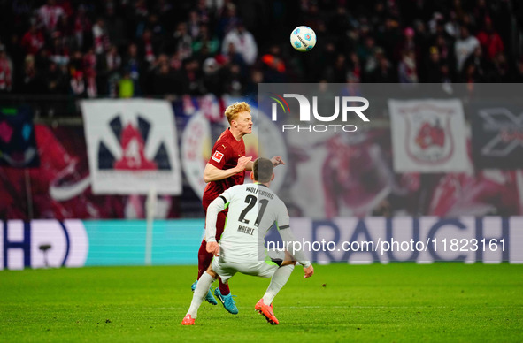 Joakim Maehle of VfL Wolfsburg and Nicolas Seiwald of RB Leipzig battle for the ball during the Bundesliga match between RB Leipzig and VfL...