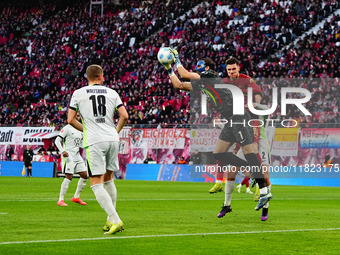 Kamil Grabara of VfL Wolfsburg  controls the ball during the Bundesliga match between RB Leipzig and VfL Wolfsburg at Red Bull Arena, Leipzi...