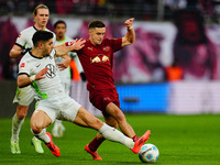 Pavao Pervan of VfL Wolfsburg and Christoph Baumgartner of RB Leipzig battle for the ball during the Bundesliga match between RB Leipzig and...