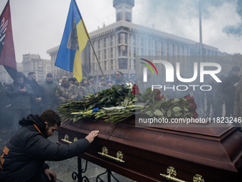 People attend a funeral ceremony for Ukrainian serviceman and founder of FC Obolon's ultras movement, Pavlo Vedybida, nicknamed ''Obolonchik...