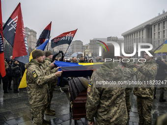 People attend a funeral ceremony for Ukrainian serviceman and founder of FC Obolon's ultras movement, Pavlo Vedybida, nicknamed ''Obolonchik...