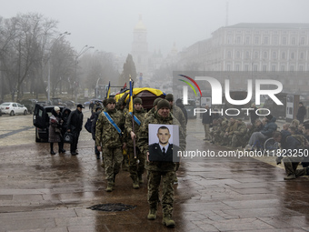 People attend a funeral service for Ukrainian serviceman and founder of FC Obolon's ultras movement, Pavlo Vedybida, nicknamed ''Obolonchik,...