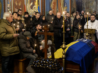 People attend a funeral service for Ukrainian serviceman and founder of FC Obolon's ultras movement, Pavlo Vedybida, nicknamed ''Obolonchik,...