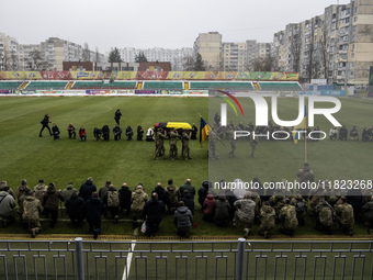 People attend a funeral ceremony for Ukrainian serviceman and founder of FC Obolon's ultras movement, Pavlo Vedybida, nicknamed ''Obolonchik...