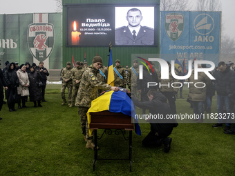 People attend a funeral ceremony for Ukrainian serviceman and founder of FC Obolon's ultras movement, Pavlo Vedybida, nicknamed ''Obolonchik...