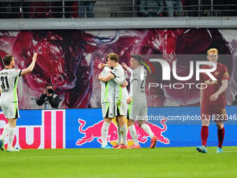 Kevin Behrens of VfL Wolfsburg  celebrates the teams fifth goal during the Bundesliga match between RB Leipzig and VfL Wolfsburg at Red Bull...