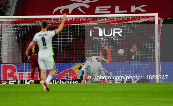 Kevin Behrens of VfL Wolfsburg  scores the teams fifth goal during the Bundesliga match between RB Leipzig and VfL Wolfsburg at Red Bull Are...