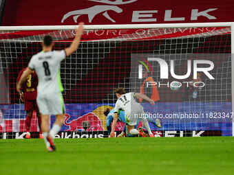 Kevin Behrens of VfL Wolfsburg  scores the teams fifth goal during the Bundesliga match between RB Leipzig and VfL Wolfsburg at Red Bull Are...