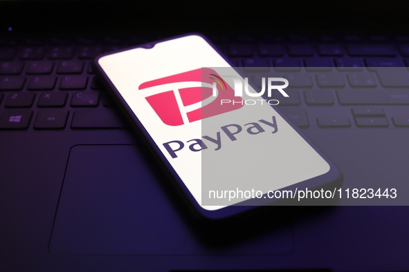 The PayPay logo appears on the screen of a smartphone in Reno, United States, on November 30, 2024. 