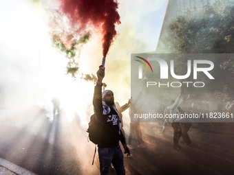 People and various associations participate in a national pro-Palestine demonstration in Rome, Italy, on November 30, 2024, against the geno...