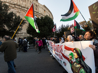 People and various associations participate in a national pro-Palestine demonstration in Rome, Italy, on November 30, 2024, against the geno...