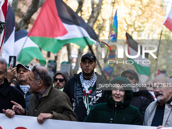 People and various associations participate in a national pro-Palestine demonstration in Rome, Italy, on November 30, 2024, against the geno...