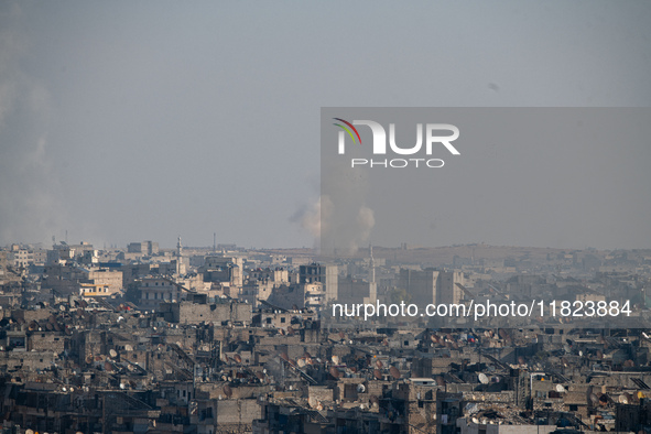 Thick columns of smoke were seen rising over the city of Aleppo on November 30, 2024, following a series of airstrikes conducted by Syrian w...