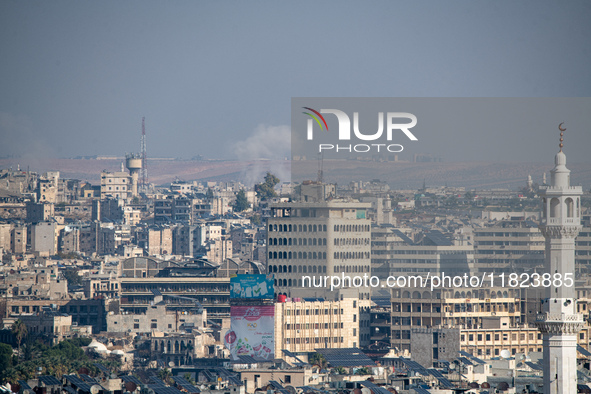 Thick columns of smoke were seen rising over the city of Aleppo on November 30, 2024, following a series of airstrikes conducted by Syrian w...