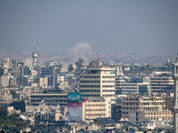 Thick columns of smoke were seen rising over the city of Aleppo on November 30, 2024, following a series of airstrikes conducted by Syrian w...