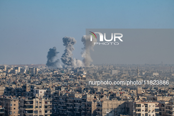 Thick columns of smoke were seen rising over the city of Aleppo on November 30, 2024, following a series of airstrikes conducted by Syrian w...