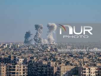 Thick columns of smoke were seen rising over the city of Aleppo on November 30, 2024, following a series of airstrikes conducted by Syrian w...