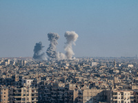 Thick columns of smoke were seen rising over the city of Aleppo on November 30, 2024, following a series of airstrikes conducted by Syrian w...