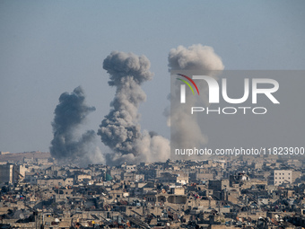 Thick columns of smoke were seen rising over the city of Aleppo on November 30, 2024, following a series of airstrikes conducted by Syrian w...