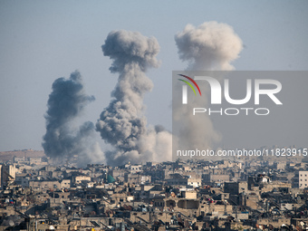 Thick columns of smoke were seen rising over the city of Aleppo on November 30, 2024, following a series of airstrikes conducted by Syrian w...