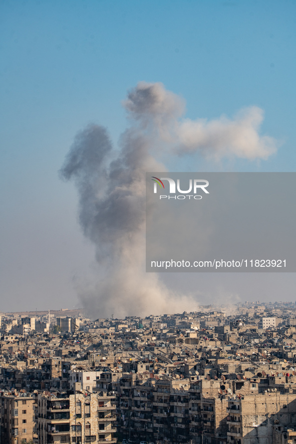 Thick columns of smoke were seen rising over the city of Aleppo on November 30, 2024, following a series of airstrikes conducted by Syrian w...