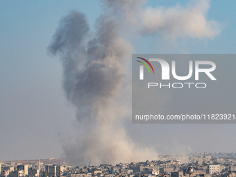 Thick columns of smoke were seen rising over the city of Aleppo on November 30, 2024, following a series of airstrikes conducted by Syrian w...