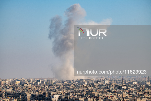 Thick columns of smoke were seen rising over the city of Aleppo on November 30, 2024, following a series of airstrikes conducted by Syrian w...