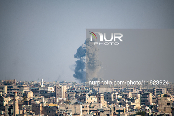 Thick columns of smoke were seen rising over the city of Aleppo on November 30, 2024, following a series of airstrikes conducted by Syrian w...