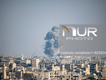 Thick columns of smoke were seen rising over the city of Aleppo on November 30, 2024, following a series of airstrikes conducted by Syrian w...