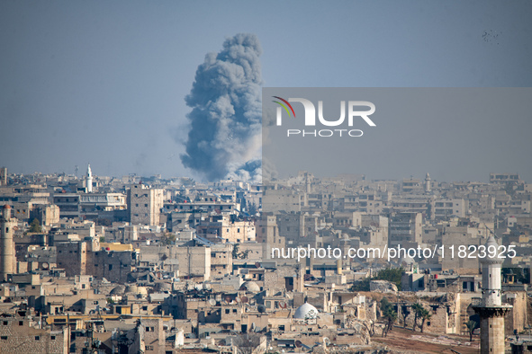 Thick columns of smoke were seen rising over the city of Aleppo on November 30, 2024, following a series of airstrikes conducted by Syrian w...