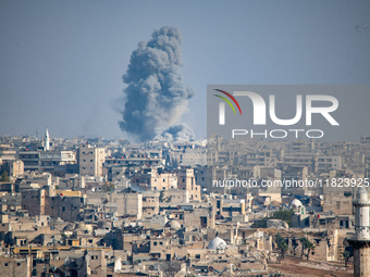 Thick columns of smoke were seen rising over the city of Aleppo on November 30, 2024, following a series of airstrikes conducted by Syrian w...