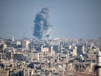 Thick columns of smoke were seen rising over the city of Aleppo on November 30, 2024, following a series of airstrikes conducted by Syrian w...