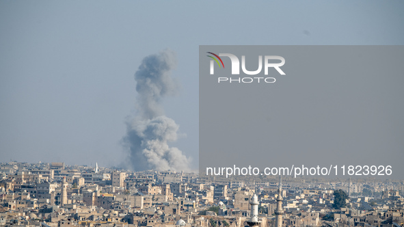 Thick columns of smoke were seen rising over the city of Aleppo on November 30, 2024, following a series of airstrikes conducted by Syrian w...