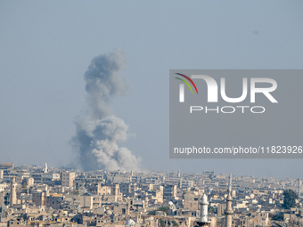 Thick columns of smoke were seen rising over the city of Aleppo on November 30, 2024, following a series of airstrikes conducted by Syrian w...