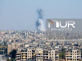 Thick columns of smoke were seen rising over the city of Aleppo on November 30, 2024, following a series of airstrikes conducted by Syrian w...