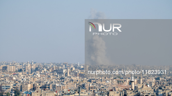 Thick columns of smoke were seen rising over the city of Aleppo on November 30, 2024, following a series of airstrikes conducted by Syrian w...