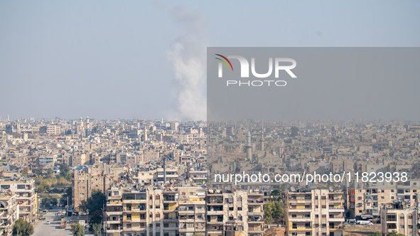 Thick columns of smoke were seen rising over the city of Aleppo on November 30, 2024, following a series of airstrikes conducted by Syrian w...