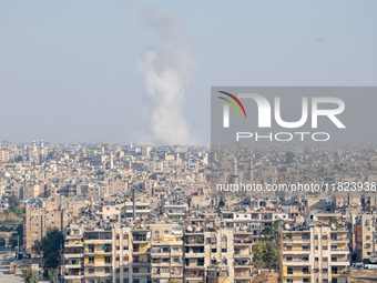 Thick columns of smoke were seen rising over the city of Aleppo on November 30, 2024, following a series of airstrikes conducted by Syrian w...