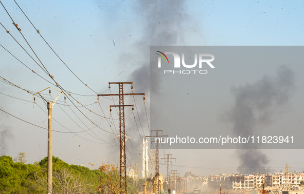 Thick columns of smoke were seen rising over the city of Aleppo on November 30, 2024, following a series of airstrikes conducted by Syrian w...