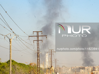 Thick columns of smoke were seen rising over the city of Aleppo on November 30, 2024, following a series of airstrikes conducted by Syrian w...