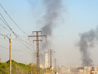 Thick columns of smoke were seen rising over the city of Aleppo on November 30, 2024, following a series of airstrikes conducted by Syrian w...