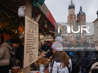 Touriststs visit traditional Christmas market at the Main Square in Krakow, Poland on Nobember 30th, 2024.  (