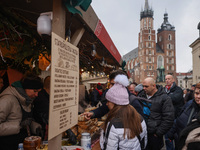 Touriststs visit traditional Christmas market at the Main Square in Krakow, Poland on Nobember 30th, 2024.  (